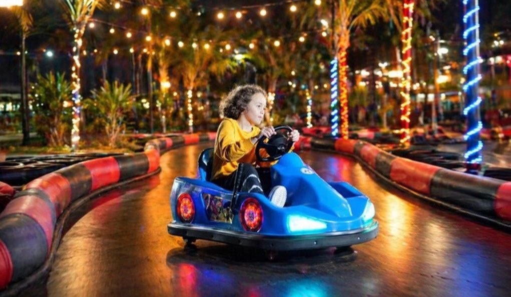 Kids karting activation on a lit outdoor track at an event